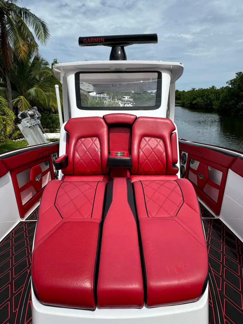 Slide: The Image of Luxurious 2022 Deep Impact 399 boat with red leather seating and sleek design. - 34