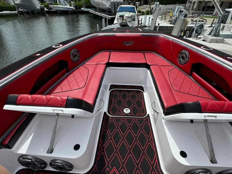 Slide: The Image of Luxurious 2022 Deep Impact 399 boat with red and black seating, docked by the water. - 42