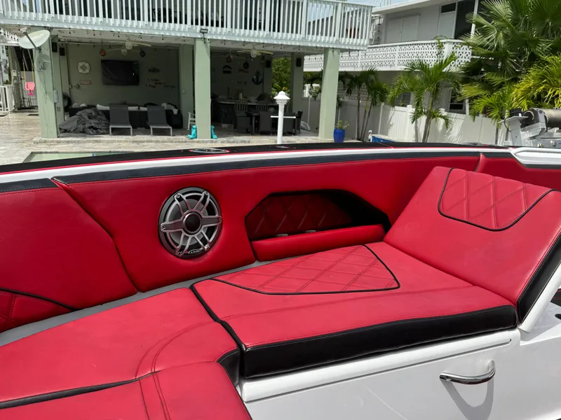 Slide: The Image of Luxurious red and black seating on 2022 Deep Impact 399 boat, featuring stylish speaker. - 45