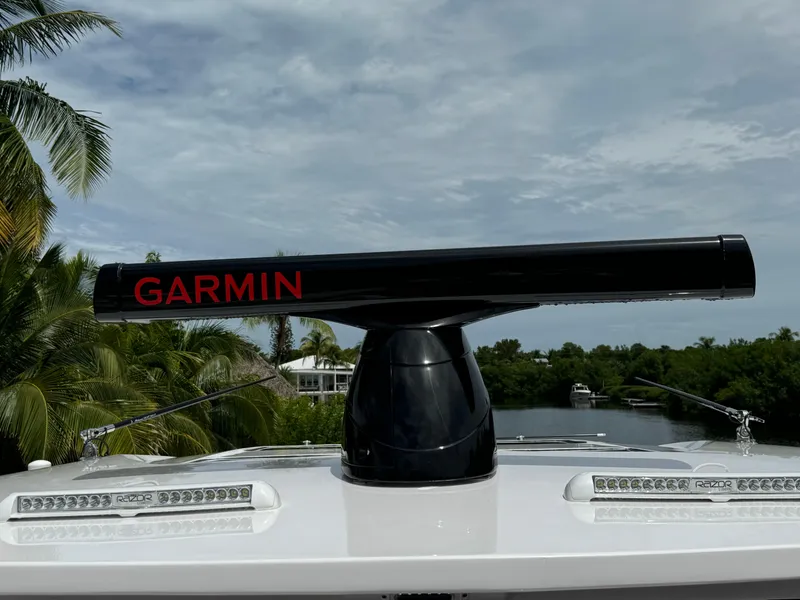Slide: The Image of Garmin radar on 2022 Deep Impact 399 boat, surrounded by tropical scenery. - 48