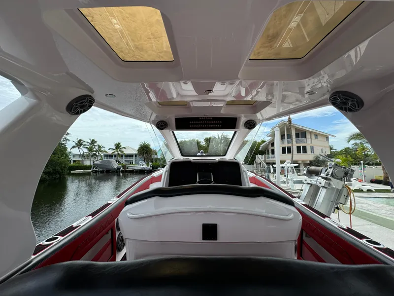 Slide: The Image of Interior view of 2022 Deep Impact 399 boat, featuring sleek design and waterfront setting. - 9