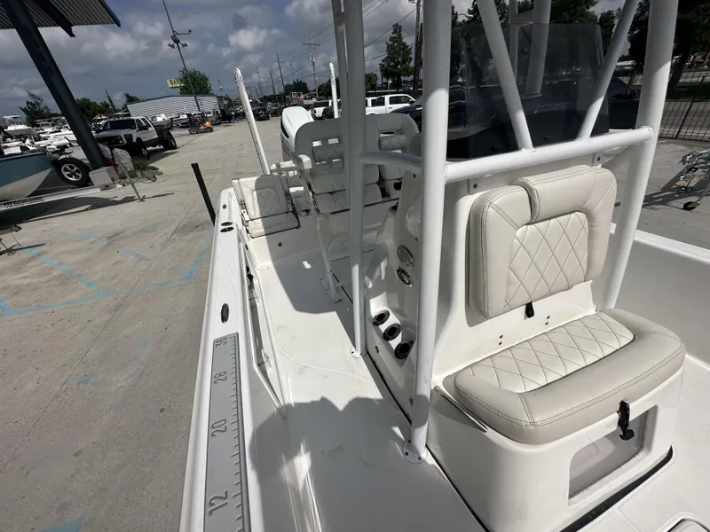 Slide: The Image of 2022 Blue Wave 2400 PURE BAY boat interior with white seating and fishing rod holders. - 13