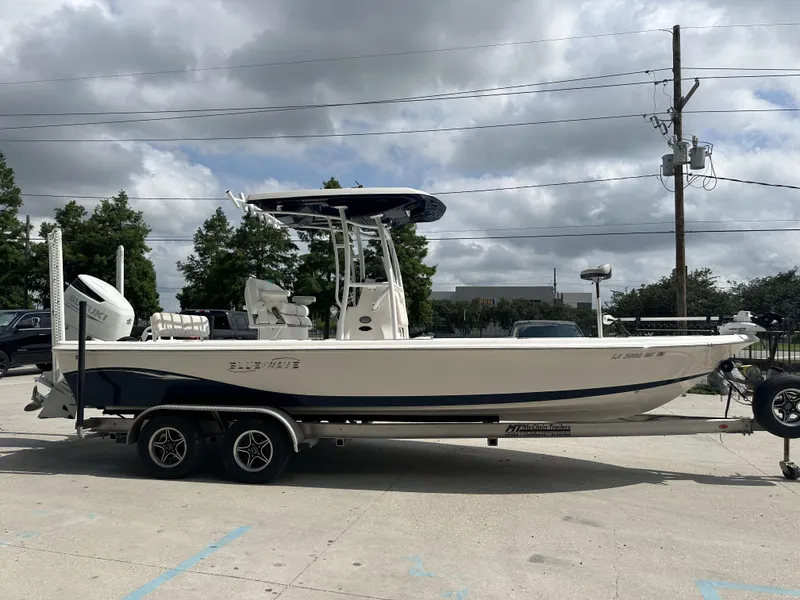 Slide: The Image of 2022 Blue Wave 2400 PURE BAY boat on trailer with Suzuki outboard motor. - 15