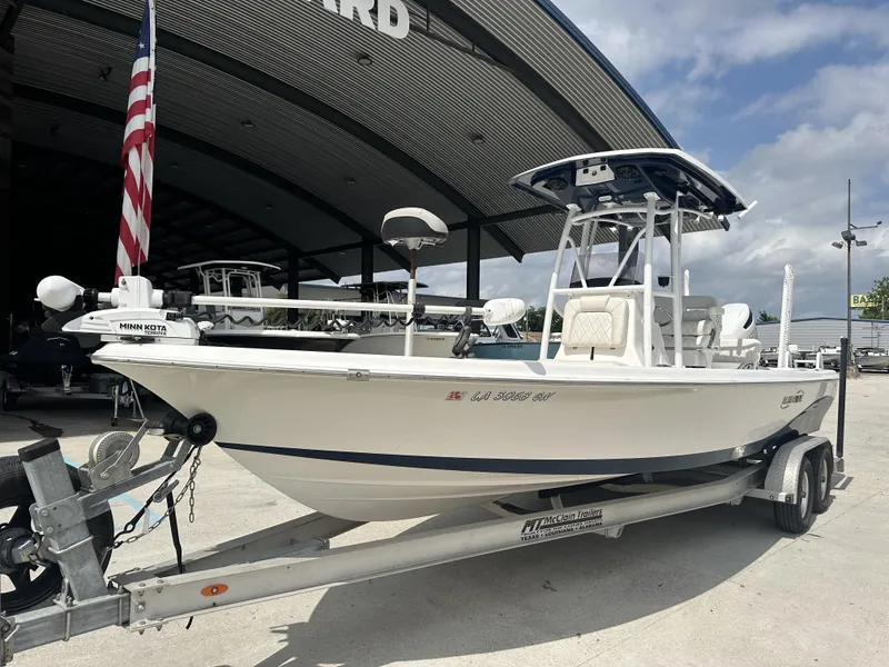 Slide: The Image of 2022 Blue Wave 2400 PURE BAY boat on trailer, Minn Kota trolling motor, American flag. - 18