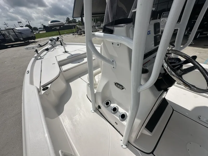 Slide: The Image of 2022 Blue Wave 2400 PURE BAY boat interior, featuring steering console and deck layout. - 19
