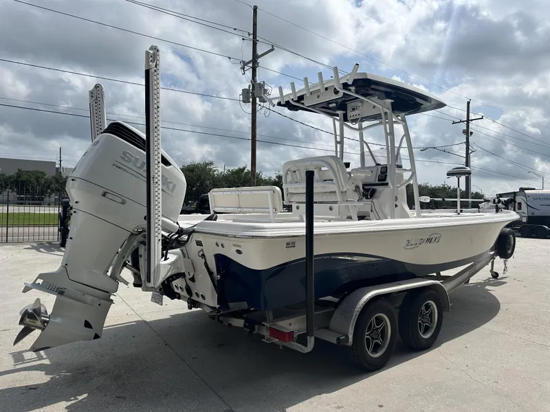 Slide: The Image of 2022 Blue Wave 2400 PURE BAY boat with Suzuki outboard motor on trailer. - 9