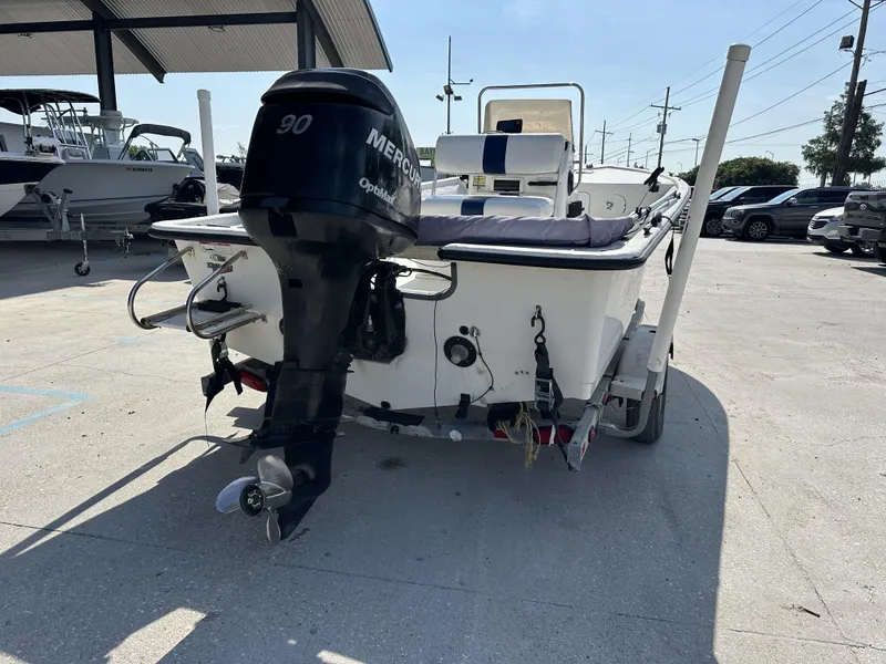 Slide: The Image of 2009 Trophy 181 Bay Boat with Mercury 90 outboard motor in a parking lot. - 7