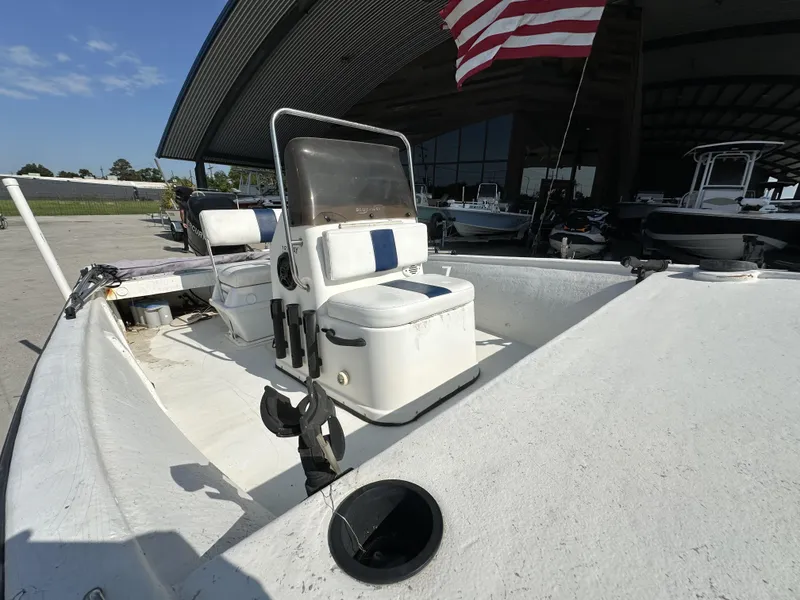 Slide: The Image of 2009 Trophy 181 Bay Boat with seating and storage, docked under a canopy. - 9