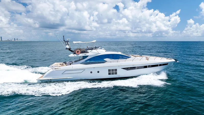 Slide: The Image of Luxury 2019 Azimut 77S yacht cruising on open sea under blue sky. - 0