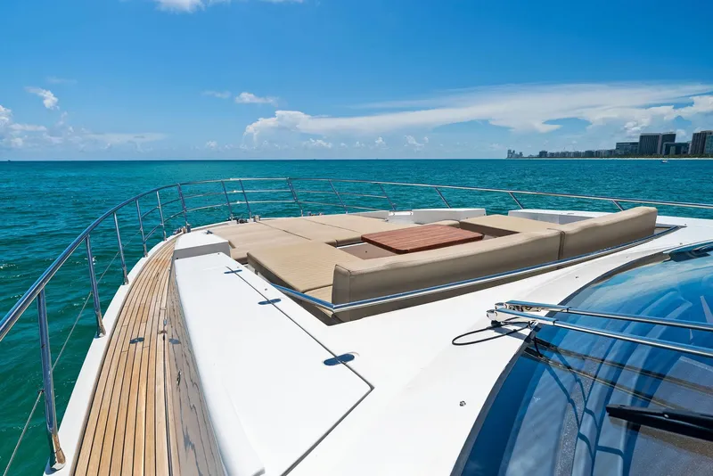 Slide: The Image of Azimut 77S 2019 yacht deck with sun loungers, ocean view, and city skyline. - 12