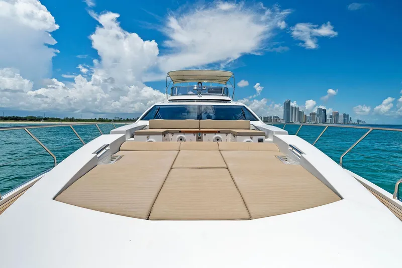 Slide: The Image of 2019 Azimut 77S yacht with sun deck, ocean view, and city skyline in the background. - 13