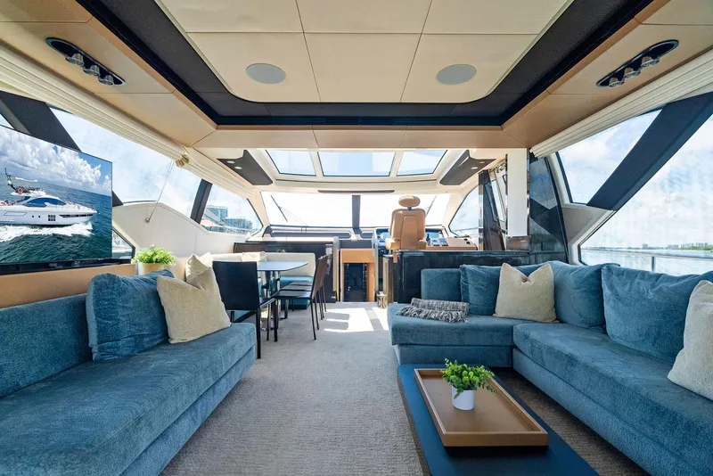 Slide: The Image of Luxurious interior of 2019 Azimut 77S yacht with plush seating and panoramic windows. - 16