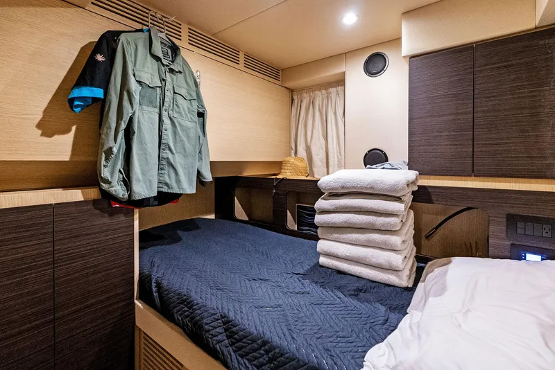 Slide: The Image of Luxurious cabin interior of 2019 Azimut 77S yacht with bed and folded towels. - 26