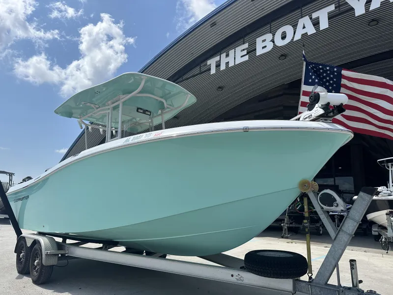 Slide: The Image of 2019 Clearwater 2300 boat on trailer at The Boat Yard, American flag visible. - 20