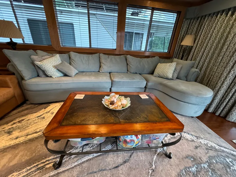 Slide: The Image of Two wooden chairs on a 2005 Fantasy Houseboat deck overlooking a serene lake. - 17