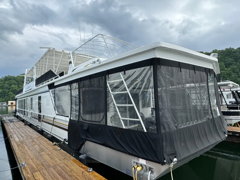 Slide: The Image of 2005 Fantasy Houseboat 19x90 docked with covered deck. - 2