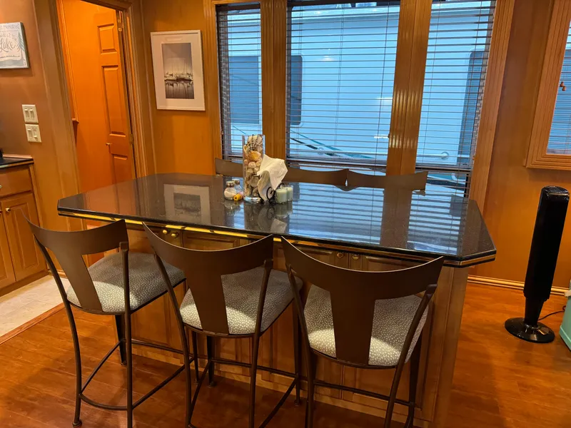 Slide: The Image of Spacious living area in a 2005 Fantasy Houseboat 19x90 with a cozy sectional sofa. - 21