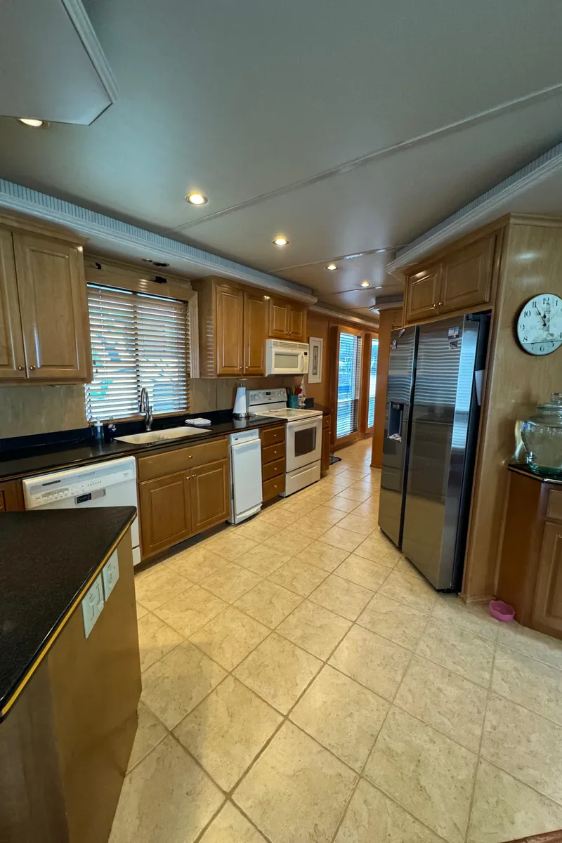Slide: The Image of 2005 Fantasy Houseboat 19x90 interior with wooden cabinetry and large TV - 27