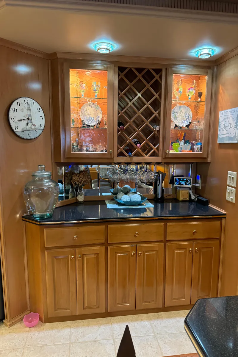 Slide: The Image of Modern kitchen area in a 2005 Fantasy Houseboat 19x90 with granite countertop and bar stools. - 28