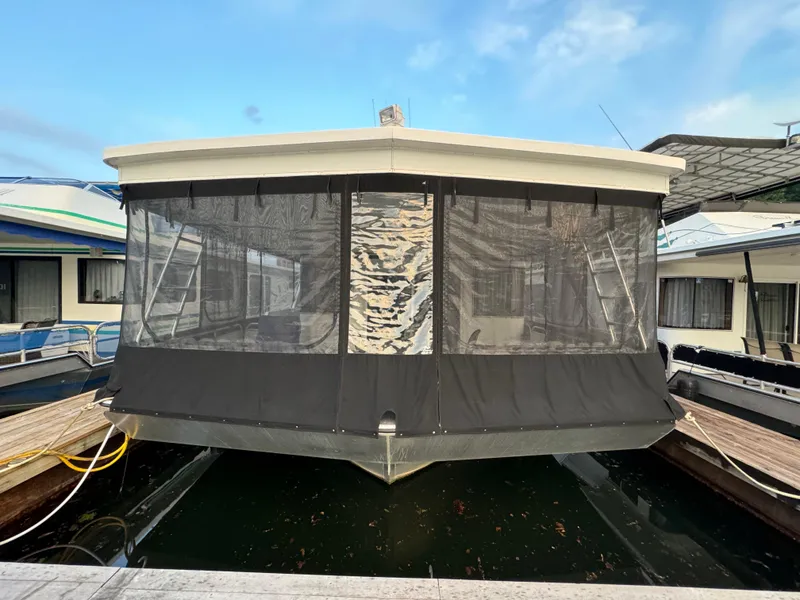 Slide: The Image of 2005 Fantasy Houseboat 19x90 docked with screened-in front deck. - 3