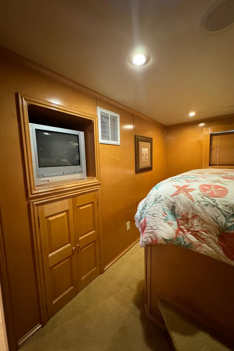 Slide: The Image of Elegant kitchen area in a 2005 Fantasy Houseboat 19x90 with wooden cabinets and glass display. - 35