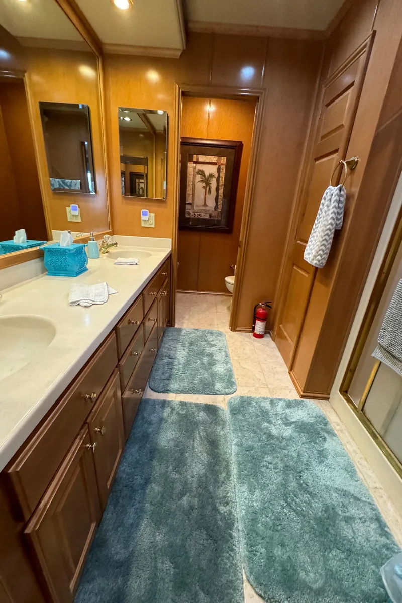 Slide: The Image of 2005 Fantasy Houseboat 19x90 bathroom with wooden cabinets, sink, and mirror. - 46