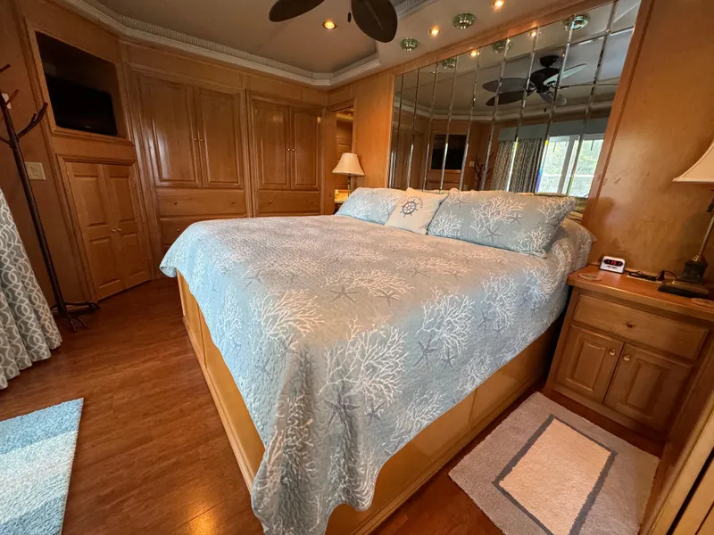 Slide: The Image of Luxurious bedroom in a 2005 Fantasy Houseboat 19x90 with mirrored wall and wooden cabinetry. - 52