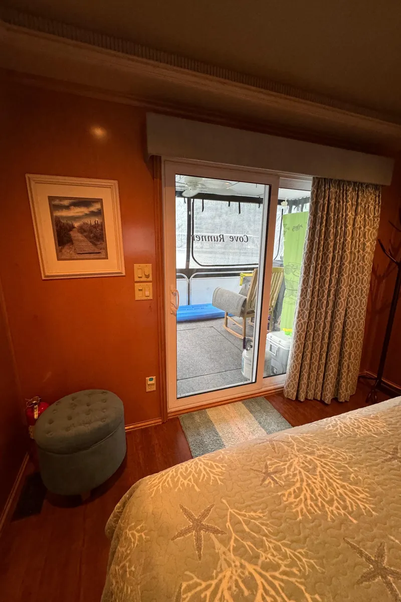 Slide: The Image of Cozy bedroom in a 2005 Fantasy Houseboat 19x90 with patio access. - 53