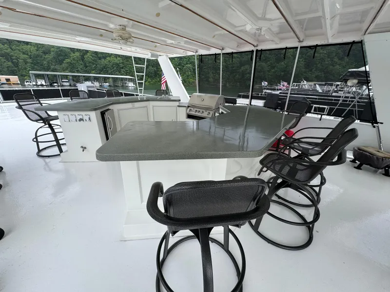 Slide: The Image of Outdoor kitchen area on a 2005 Fantasy Houseboat 19x90 with a mini fridge and dishwasher. - 8
