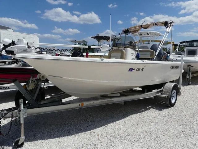Slide: The Image of 2014 Key West 176BR boat on a trailer under a blue sky. - 1