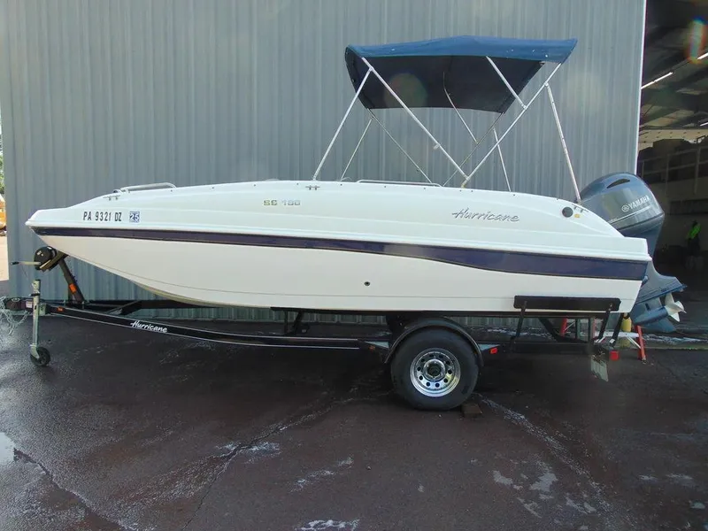 Slide: The Image of 2021 Hurricane SunDeck Sport 188 OB boat on trailer with blue canopy. - 1