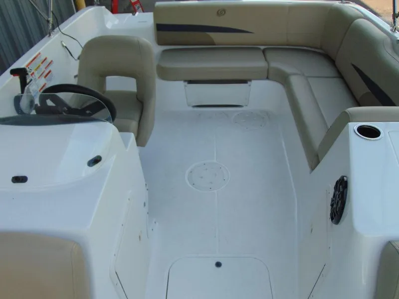 Slide: The Image of 2021 Hurricane SunDeck Sport 188 OB boat interior with beige seating and steering console. - 10