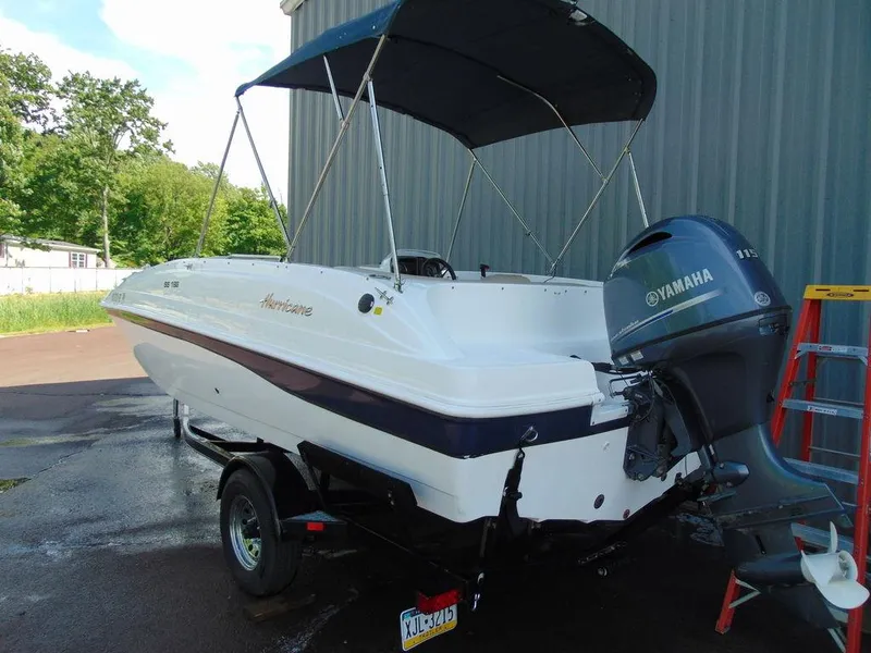 Slide: The Image of 2021 Hurricane SunDeck Sport 188 OB boat with Yamaha outboard motor on trailer. - 2
