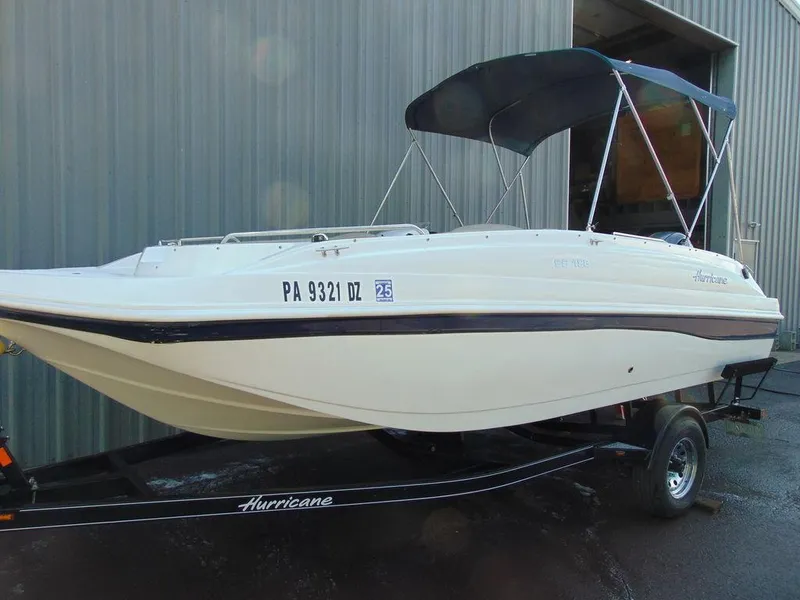 Slide: The Image of 2021 Hurricane SunDeck Sport 188 OB boat on trailer with black canopy. - 3
