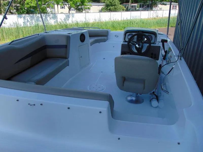 Slide: The Image of 2021 Hurricane SunDeck Sport 188 OB boat interior with seating and steering console. - 5