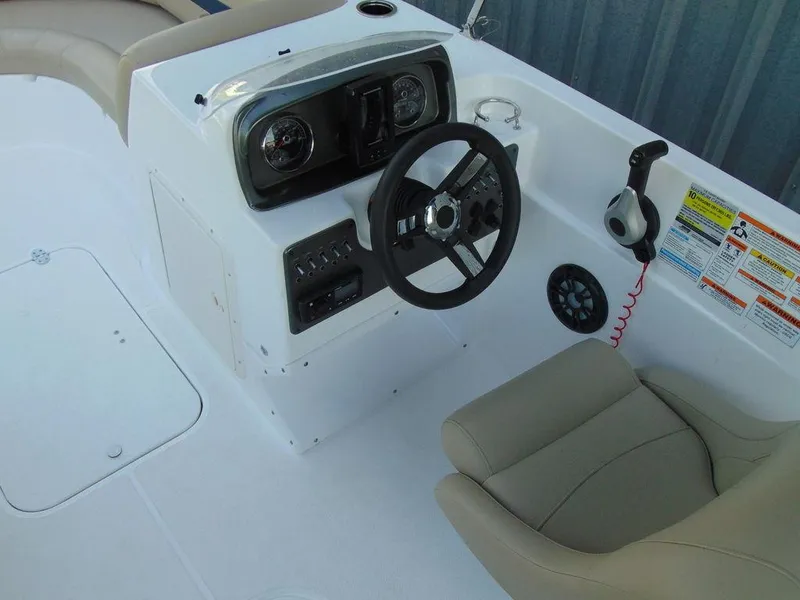 Slide: The Image of 2021 Hurricane SunDeck Sport 188 OB boat cockpit with steering wheel and controls. - 6