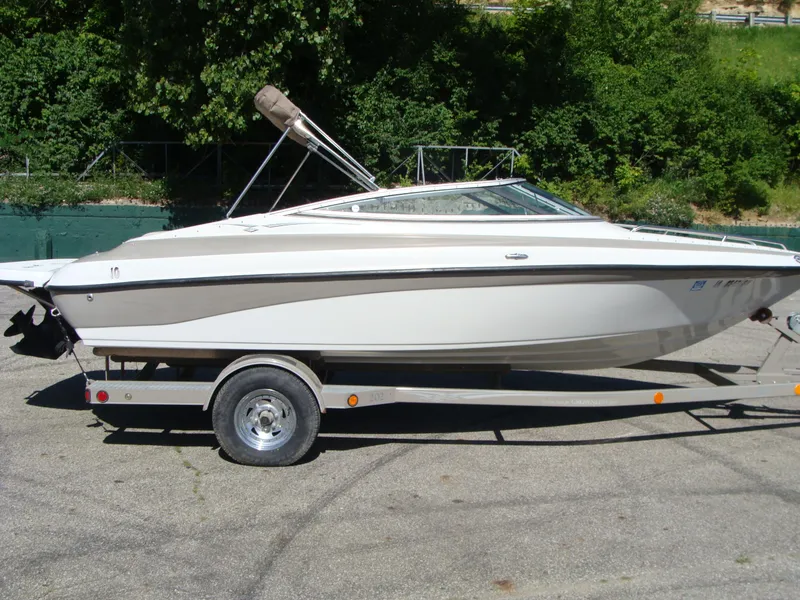 Slide: The Image of 2005 Crownline Bowrider 202 BR on trailer, side view, parked outdoors. - 10