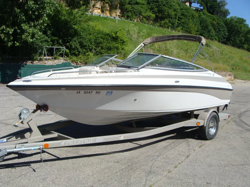 Slide: The Image of 2005 Crownline Bowrider 202 BR on trailer, parked outdoors. - 13