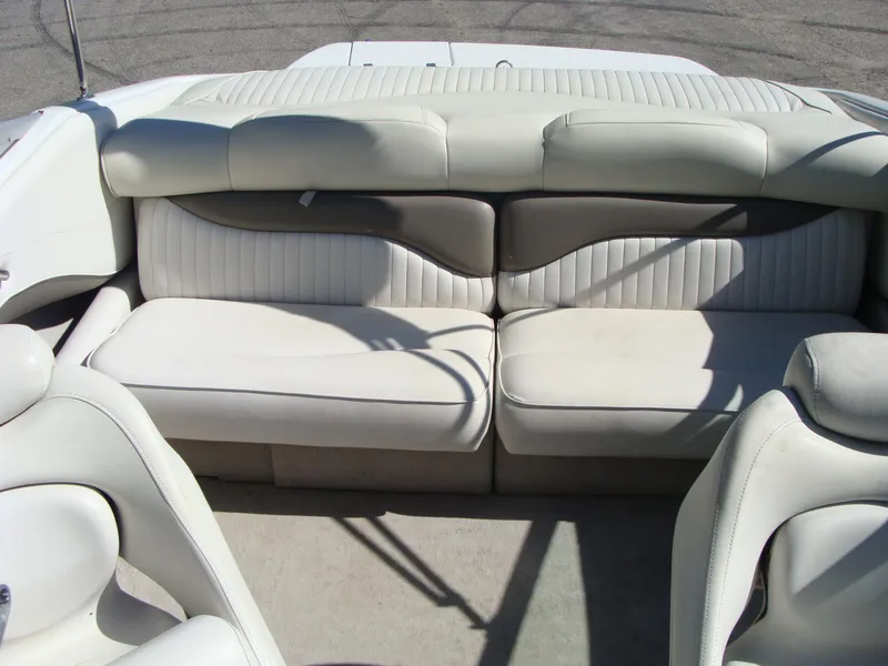 Slide: The Image of 2005 Crownline Bowrider 202 BR interior seating with white and gray upholstery. - 7