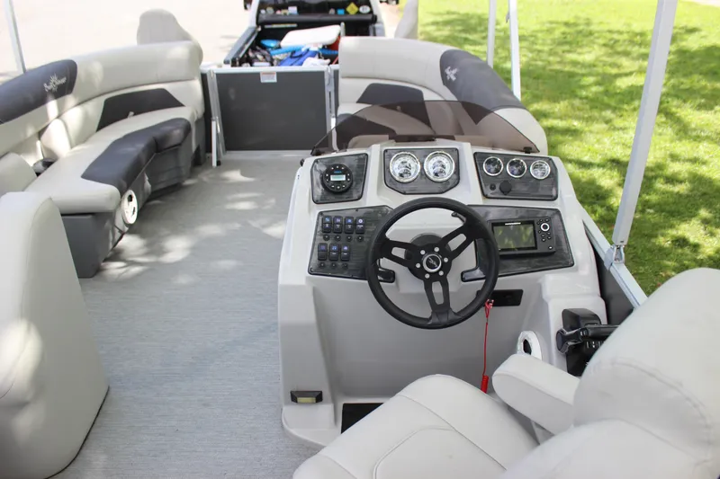 Slide: The Image of 2021 SunChaser Geneva Cruise 24 SB boat interior with steering console and seating. - 11