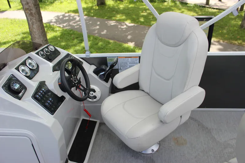 Slide: The Image of Captain's chair and helm of 2021 SunChaser Geneva Cruise 24 SB pontoon boat. - 14