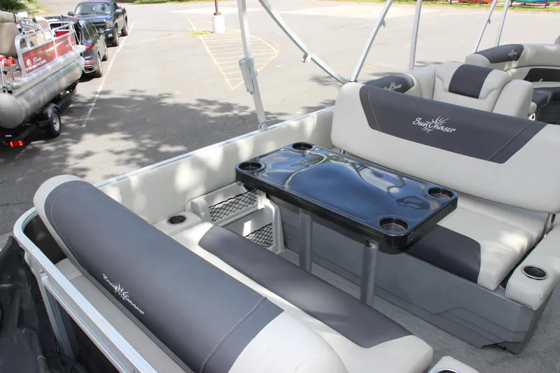 Slide: The Image of 2021 SunChaser Geneva Cruise 24 SB pontoon boat interior with seating and table. - 16