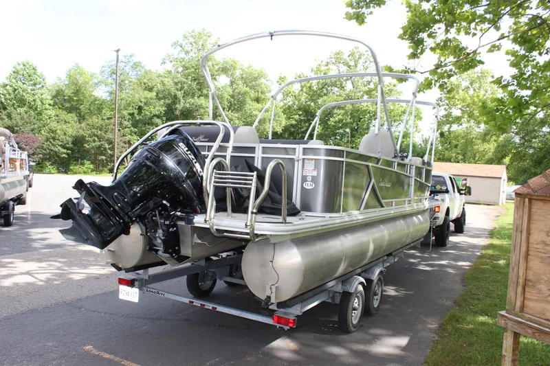 Slide: The Image of 2021 SunChaser Geneva Cruise 24 SB pontoon boat on trailer in parking lot. - 23