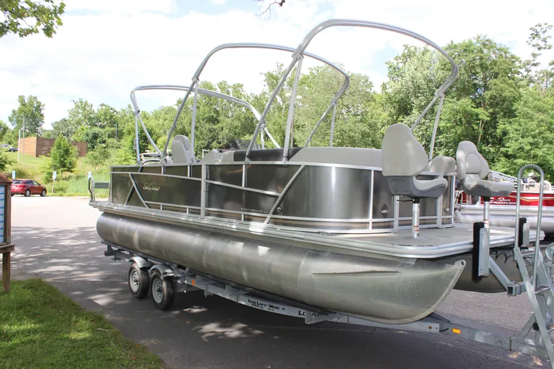 Slide: The Image of 2021 SunChaser Geneva Cruise 24 SB pontoon boat on a trailer in a park. - 25