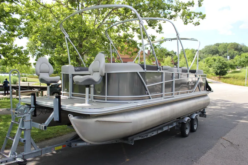Slide: The Image of 2021 SunChaser Geneva Cruise 24 SB pontoon boat on trailer, parked outdoors. - 28