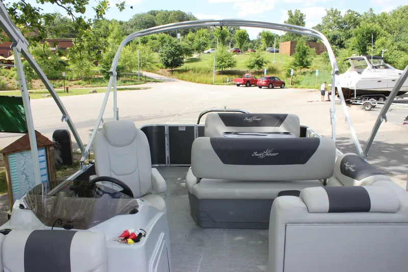 Slide: The Image of 2021 SunChaser Geneva Cruise 24 SB pontoon boat interior with seating and steering console. - 4