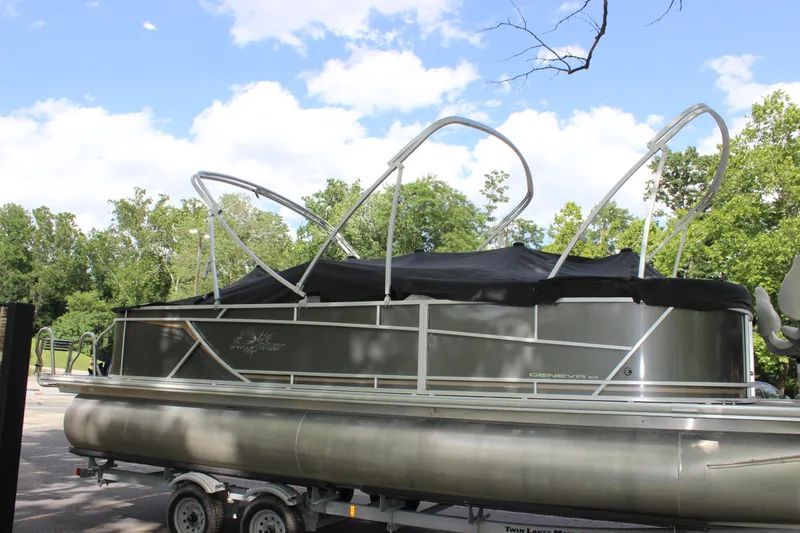 Slide: The Image of 2021 SunChaser Geneva Cruise 24 SB pontoon boat on a trailer, parked outdoors. - 41