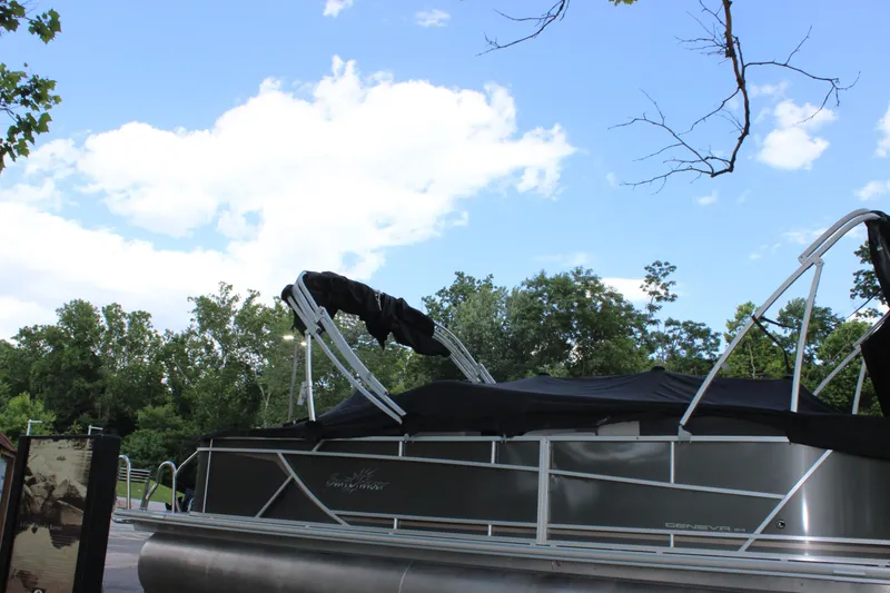 Slide: The Image of 2021 SunChaser Geneva Cruise 24 SB pontoon boat with black cover, docked near trees. - 42