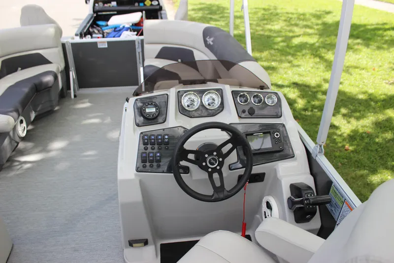Slide: The Image of 2021 SunChaser Geneva Cruise 24 SB boat interior with steering console and seating. - 8