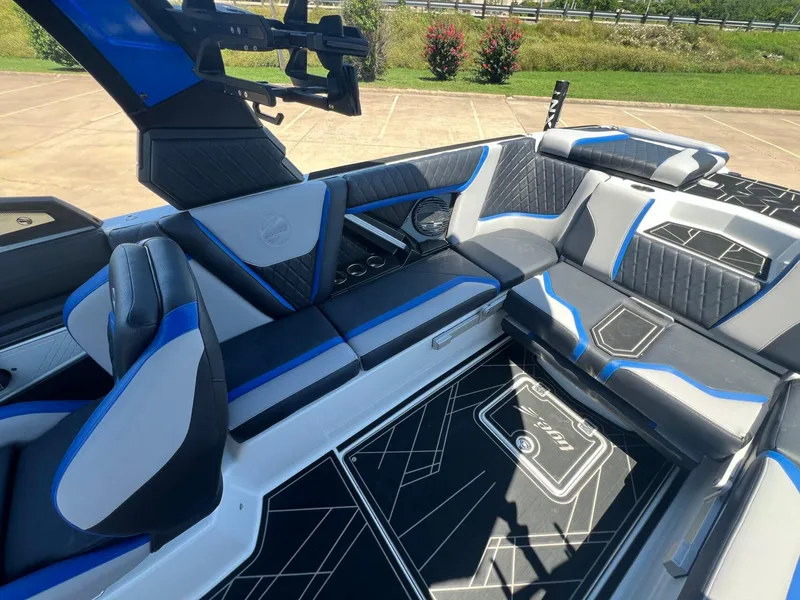 Slide: The Image of 2023 Tigé 25ZX boat interior with blue and gray seating, modern design. - 10